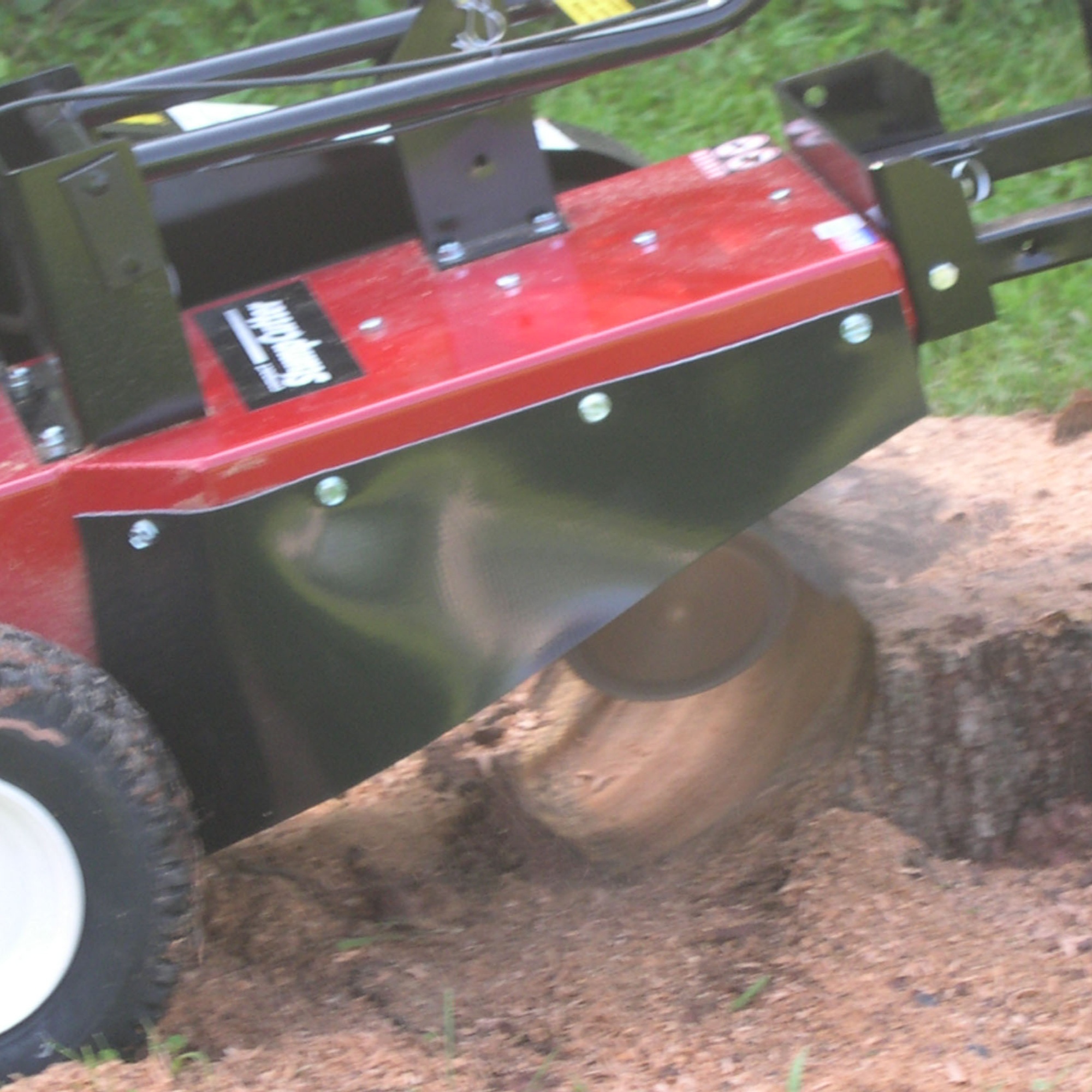 stump cutter at work - stump being grinded by the Merry Commercial machine