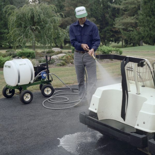 A man using a Mighty Mac 22 Gallon Sprayer cleaning a golf cart