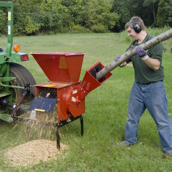 Man using Mighty Mac Hammermill Shredder Chipper TPH185 to grind tree
