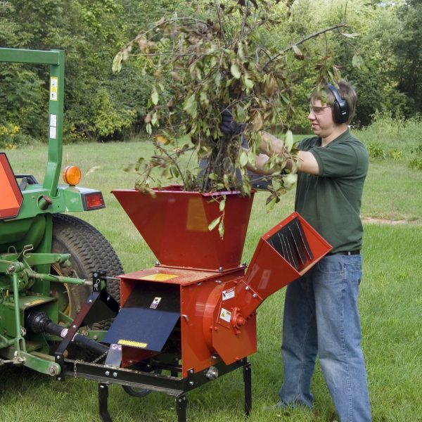 Man throwing brush into Hammermill Shredder Chipper