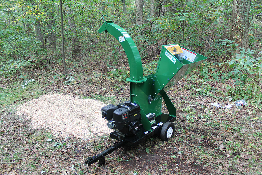 Mighty Mac TPH575E Wood Chipper next to a completed job