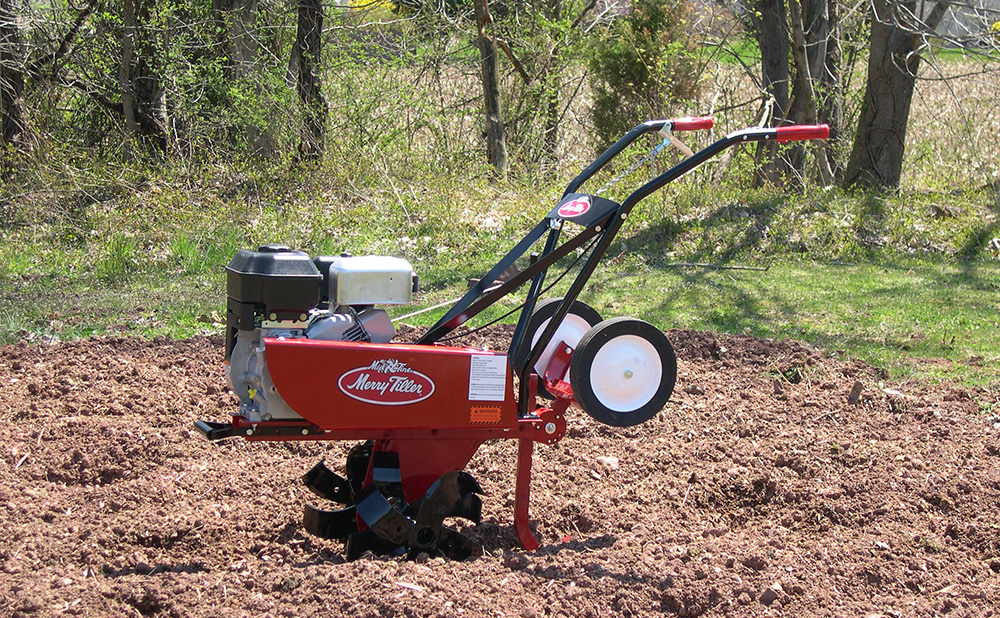 Merry Tiller International Mid-Tine Tiller in a field