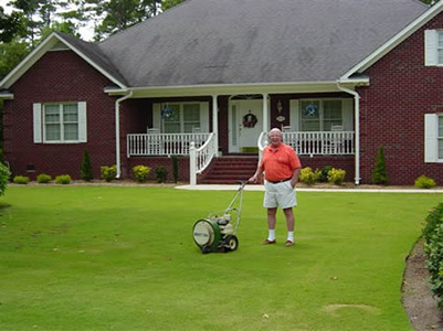 A man posing with his Mighty Mac leaf blower