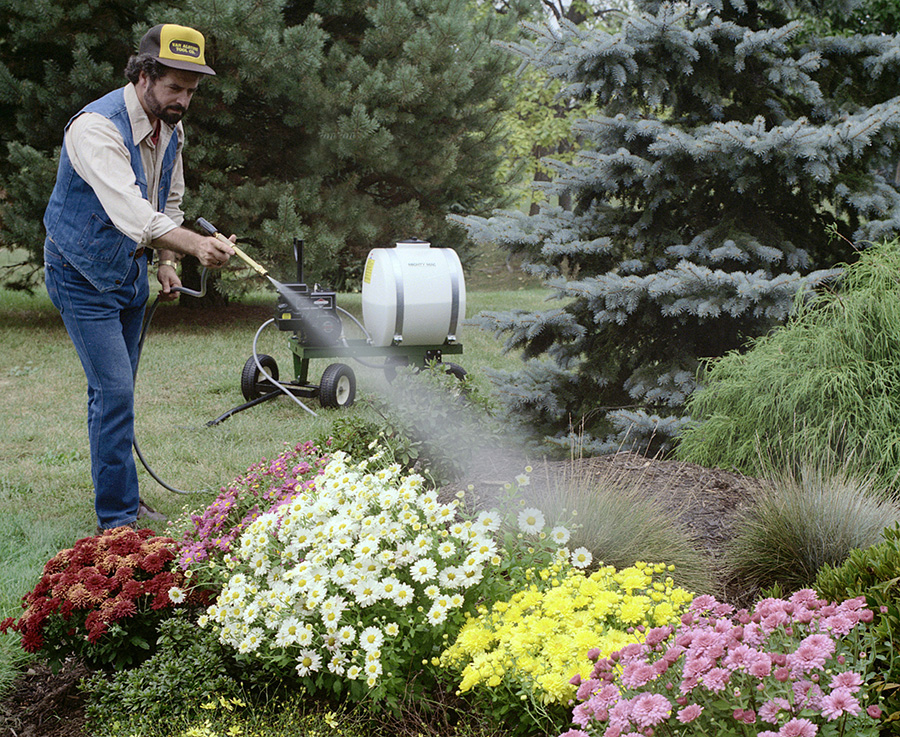 Mighty Mac PS322T 22 gallon Sprayer watering a bed of flowers